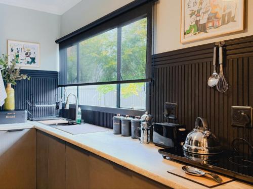 a kitchen with a sink and a counter top at Fine Stay Clarens in Clarens