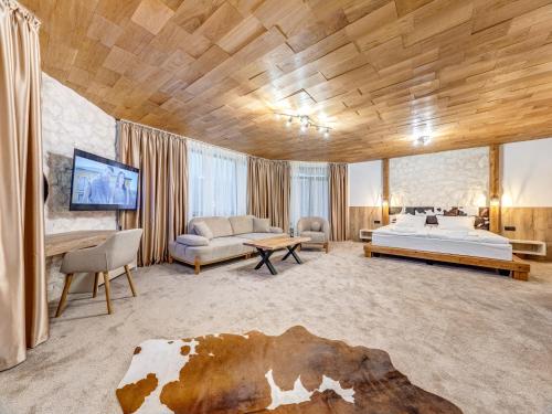 a bedroom with a bed and a cow on the floor at Къща за гости "Mirror Lake" in Smolyan