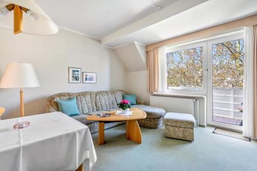 a living room with a couch and a table at Haus Passat in Büsum