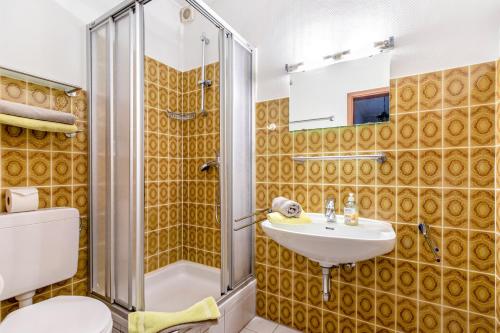 a bathroom with a shower and a sink and a toilet at Haus Passat in Büsum