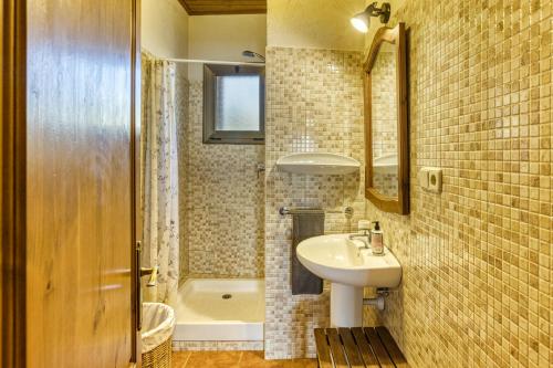 a bathroom with a sink and a toilet and a tub at Mas Pareta - La Figuera in Fonolleras