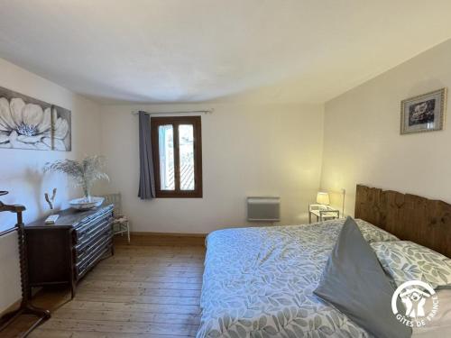 a bedroom with a bed and a window at Al clouc in CampÃ´me