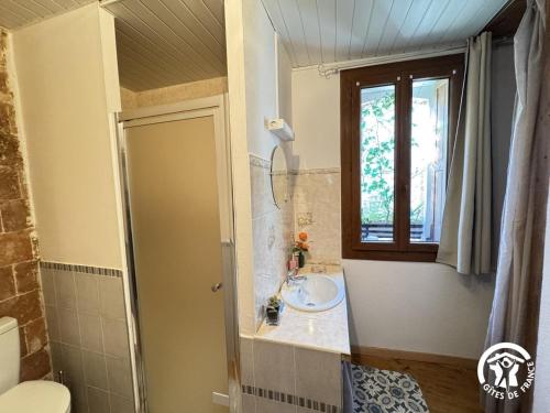 a bathroom with a sink and a window at Al clouc in CampÃ´me
