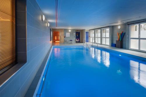 a large swimming pool in a building at DOMITYS - Les Canotiers in Argenteuil