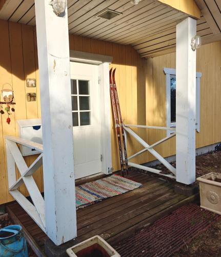 a front door of a house with a porch at Päivärannantila in Pihtipudas