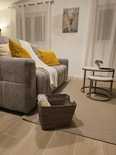a living room with a couch and a table at Le Nid De Mouroux - Disney 20 min - Clim & Parking in Mouroux