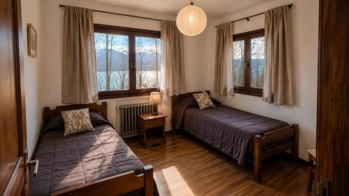 a bedroom with two beds and a window at Centrally located lakefront house in San Carlos de Bariloche