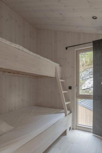 a bunk bed in a room with a window at Bratt bolig in Åndalsnes