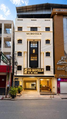 a white building with a sign on the front of it at Open Hotel by Olive - G SILVER SS hotel in Tiruppūr