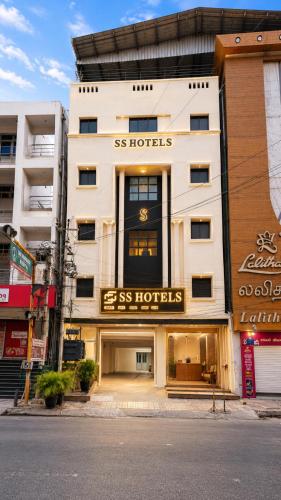 a large white building with aiss hotels sign on it at Open Hotel by Olive - G SILVER SS hotel in Tiruppūr