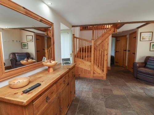 a living room with a large mirror and a staircase at Horseshoe Cottage in Middlesbrough