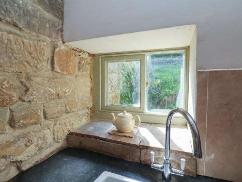 a kitchen with a sink and a window at Horseshoe Cottage in Middlesbrough