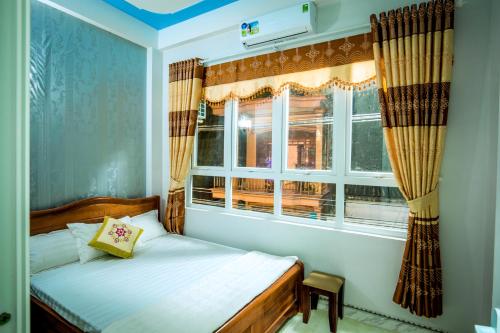 a bedroom with a bed and a window at Phuc Hau Hotel - Ly Son in Ly Son