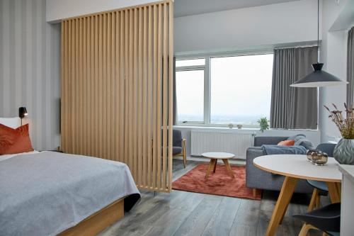 a bedroom with a bed and a living room at World Trade Center Ballerup - Forenom in Ballerup
