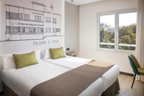 a bedroom with a large bed and a window at Sercotel Hotel Parque in Las Palmas de Gran Canaria