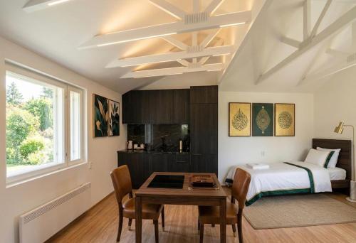 a bedroom with a bed and a table and chairs at DecaVillage Studios in Kuivanto