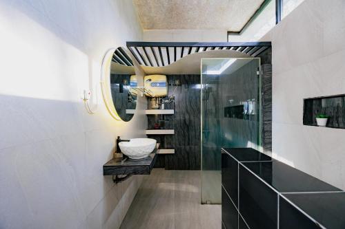 a bathroom with a sink and a mirror at The Lavana Signature Villa Alessa Puncak in Puncak