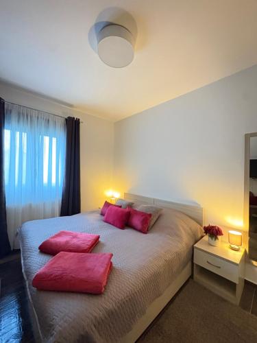a bedroom with a large bed with pink pillows at Croatia Palace - Ravna Gora in Ravna Gora