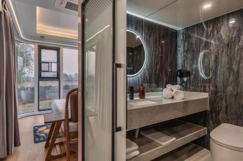 a bathroom with a sink and a toilet at Anchaviyo Resort in Vāda
