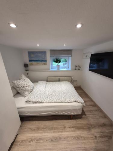 a bedroom with a white bed and a window at Reinecke Fuchs in Bad Münder am Deister