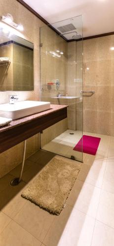 a bathroom with a sink and a glass shower at Revathi Resorts in Jajal