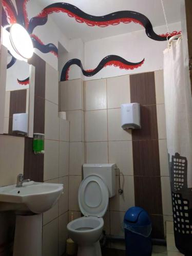 a bathroom with a toilet and a sink at The Re-Born Hostel in Timişoara