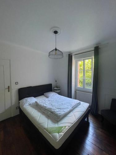 a bedroom with a bed in a room with a window at Le Rennes Gare in Rennes