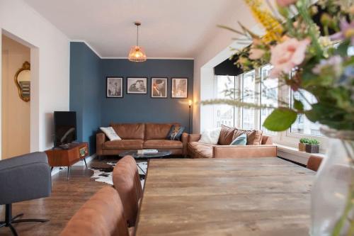 a living room with a couch and a table at Stylish Central Flat, Steps to Beach in Ostend