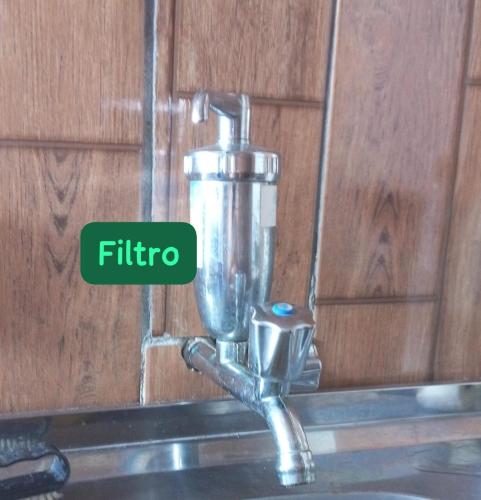 a kitchen sink faucet with the word filter at Suite Love in Paty do Alferes