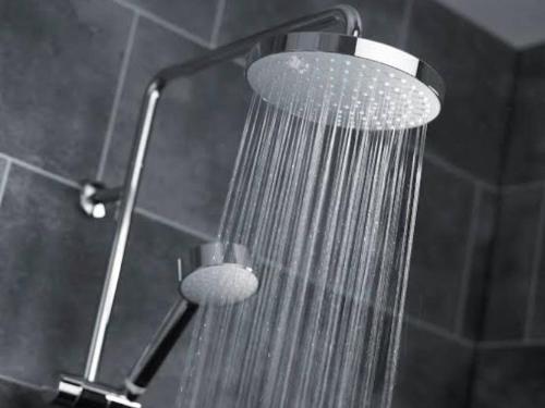 a shower with a shower head in a bathroom at Cosy Regency menylin apartment in Pretoria