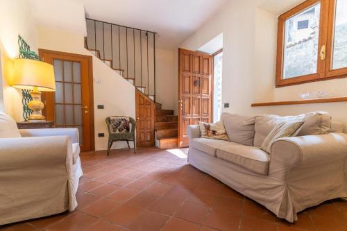 a living room with two couches and a staircase at Spacious home near Orta, 8min in Armeno