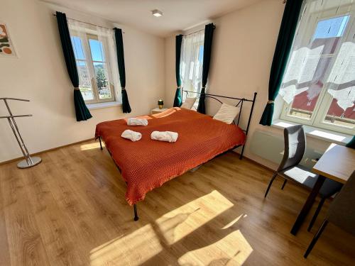 a bedroom with a bed with two towels on it at Apartmán Pepuška in Kašperské Hory