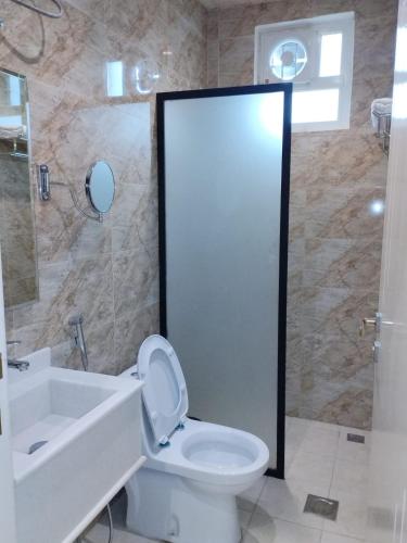 a bathroom with a toilet and a sink and a shower at ليبرا سويتس - Libra Suites in Khamis Mushayt