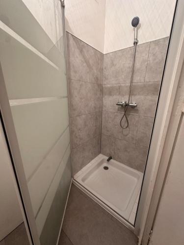 a shower stall with a toilet in a bathroom at L'Essentiel de Paray in Paray-le-Monial