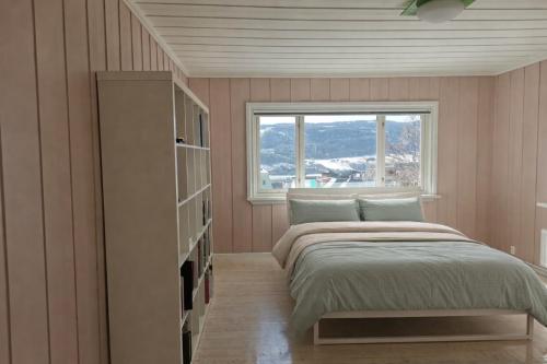 a bedroom with a bed and a window at Spacious Villa in Lillehammer in Lillehammer