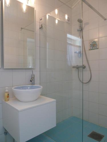 a bathroom with a sink and a glass shower at Spacious Villa in Lillehammer in Lillehammer