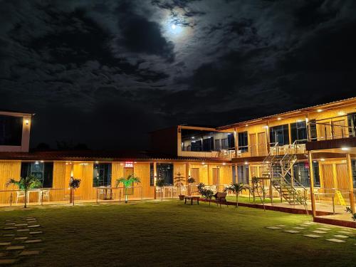 a building at night with the moon in the sky at Arya Resort And Spaa in Mahabaleshwar