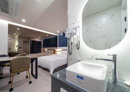 ein Krankenzimmer mit Bett und Waschbecken in der Unterkunft Rosy Hotel in Cheongju