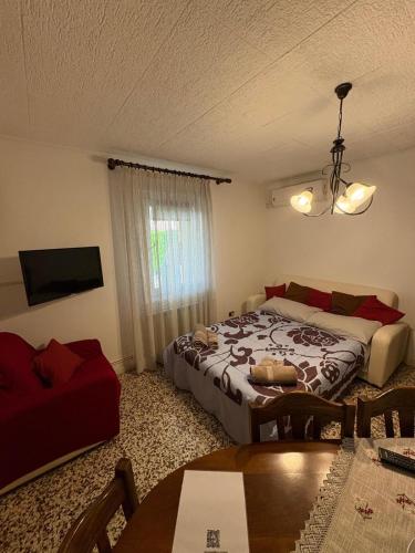 a bedroom with a bed and a couch and a table at Corte Galassi in Torsa