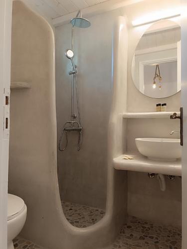 a bathroom with a sink and a shower with a mirror at Athina Studio Apartments in Kerveli