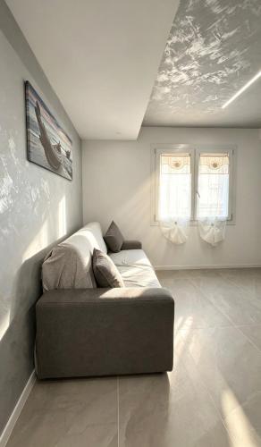 a bedroom with a bed in the corner of a room at Casa LIAM & Casa ISABEL in Chioggia