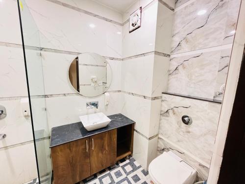 a bathroom with a sink and a toilet and a shower at Southern Stays in New Delhi