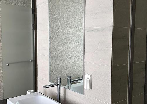 a bathroom with a mirror and a sink at Wolmido Premiers Hotel in Incheon