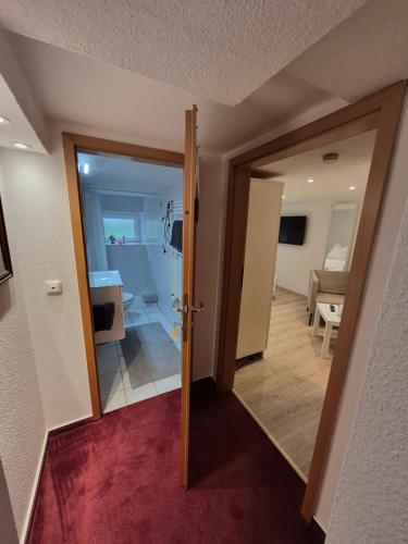 a hallway with a door leading to a bathroom at Reinecke Fuchs in Bad Münder am Deister