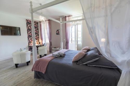 a bedroom with a bed with a canopy at Les rives de l'escamat in Sabres