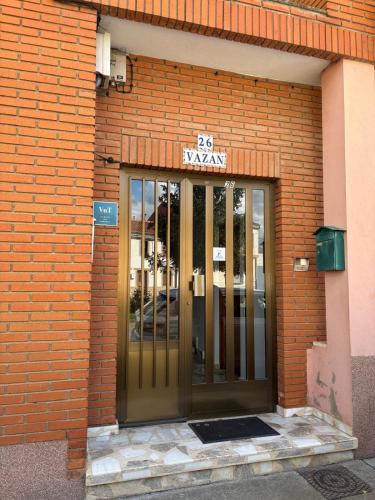 a brick building with a door with a sign on it at Casa Vazan in Laguna Dalga