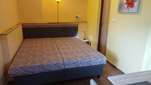 a small bedroom with a bed in a room at Apartmány-Včelka in Trpnouze