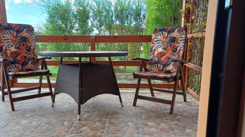 a table and two chairs on a porch at Apartmány-Včelka in Trpnouze
