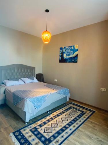 a bedroom with a bed and a rug at Makhinjauri - First Line Sea View in Makhinjauri