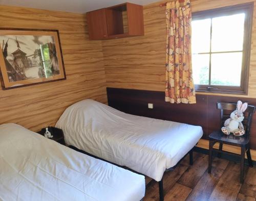 a bedroom with two beds and a window at Parc- Camping de Coullons in Coullons